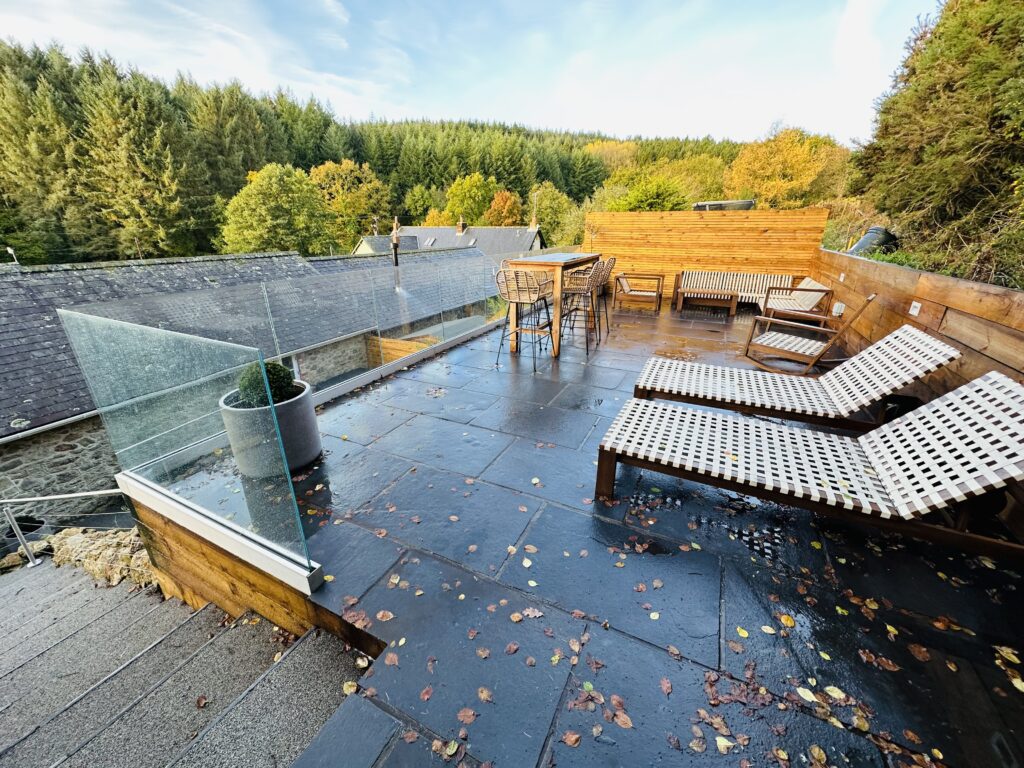 New resin patio with sun loungers and glass balustrades