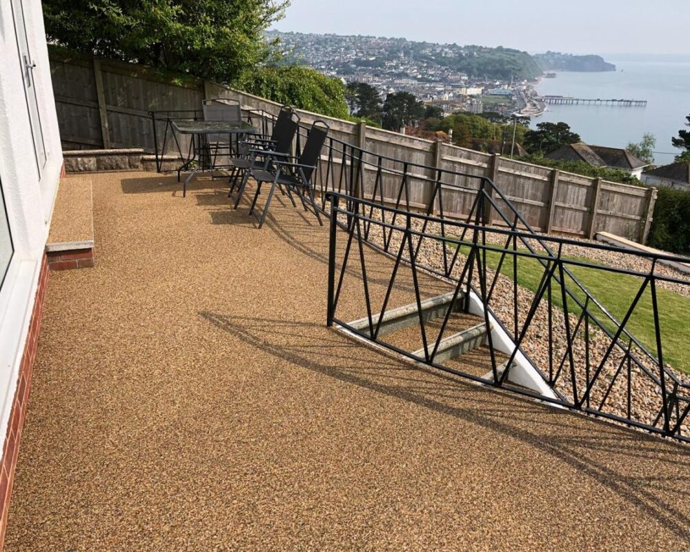Resin bound patio installation with metal balustrades and steps