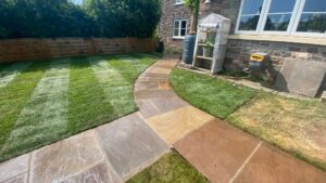 Flagstone stepping stone path through a freshly laid lawn