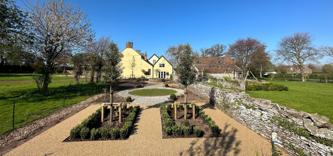 Garden landscaping with shrubs, trees and lawn on a sunny day