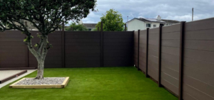 Composite fencing for windy gardens around a lawn in Devon