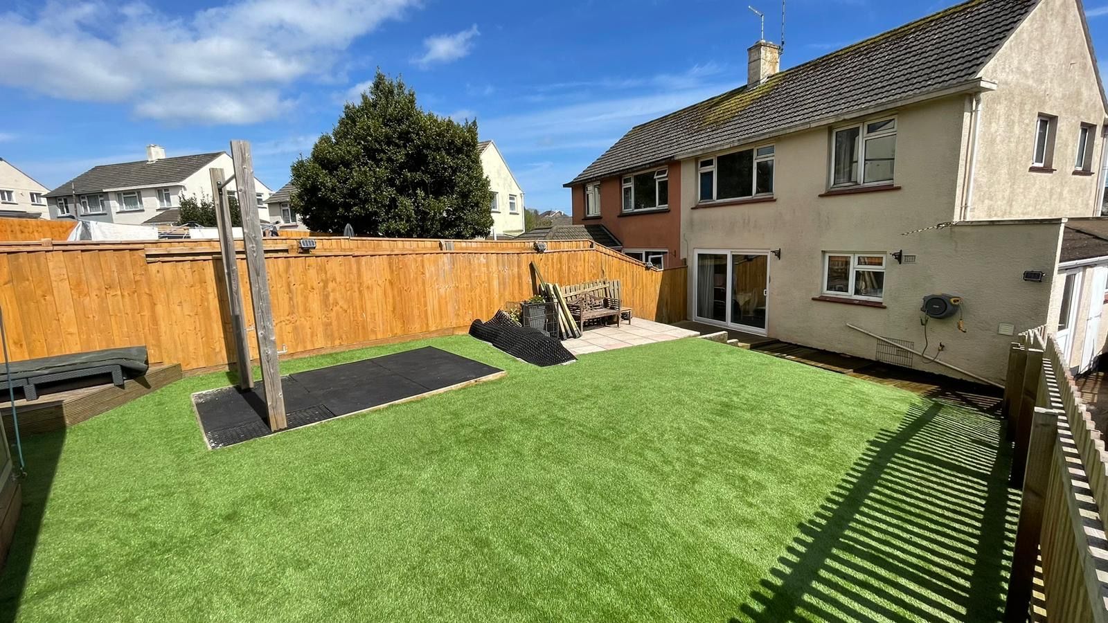 Completed artificial grass installation in residential garden