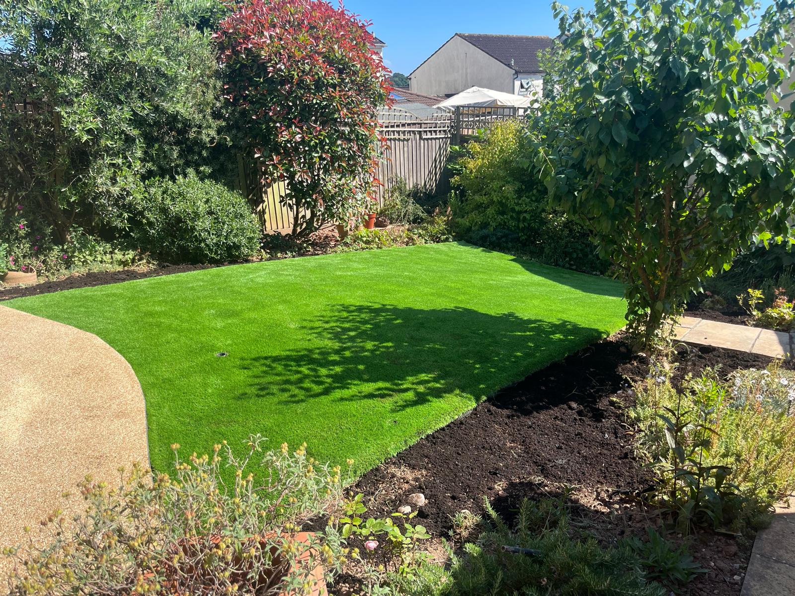Residential back garden transformation with artificial grass and borders