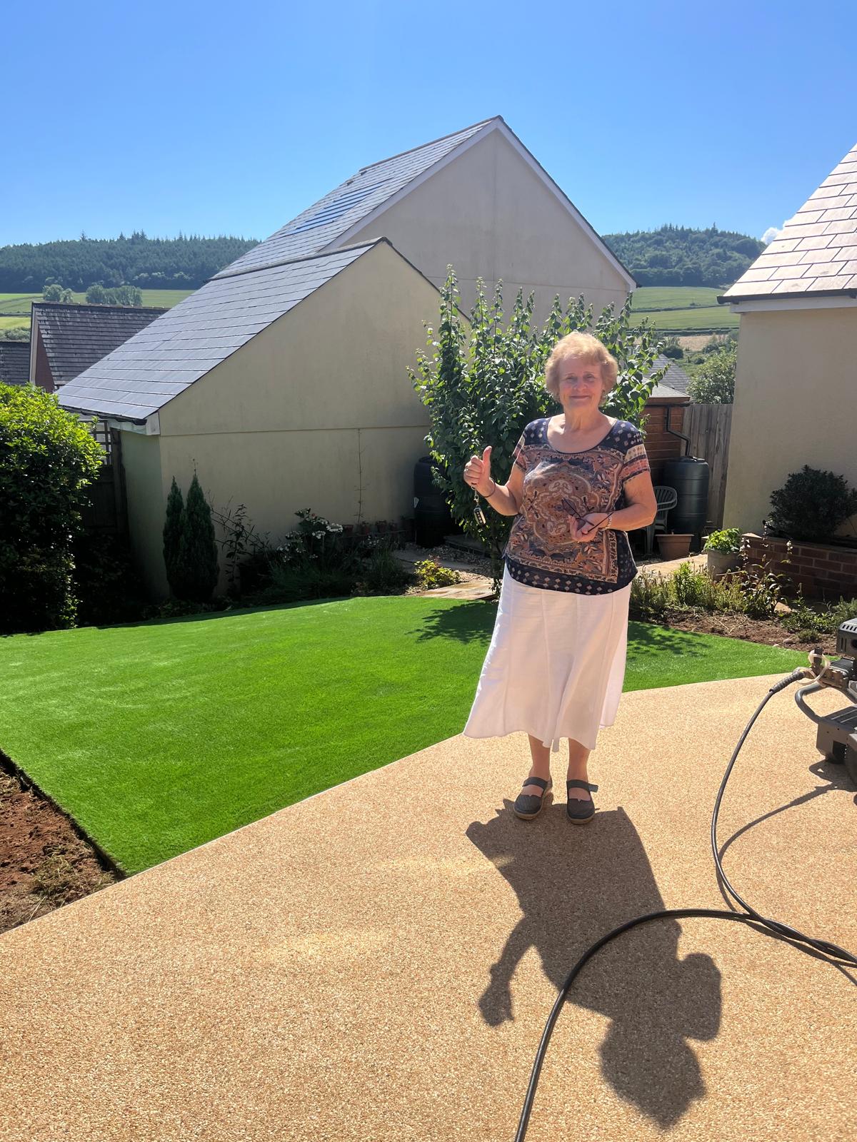 Happy customer with new artificial grass garden transformation