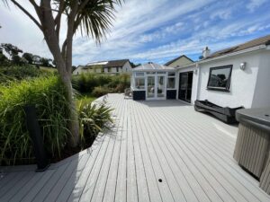 Low-maintenance grey composite decking in a coastal Devon garden