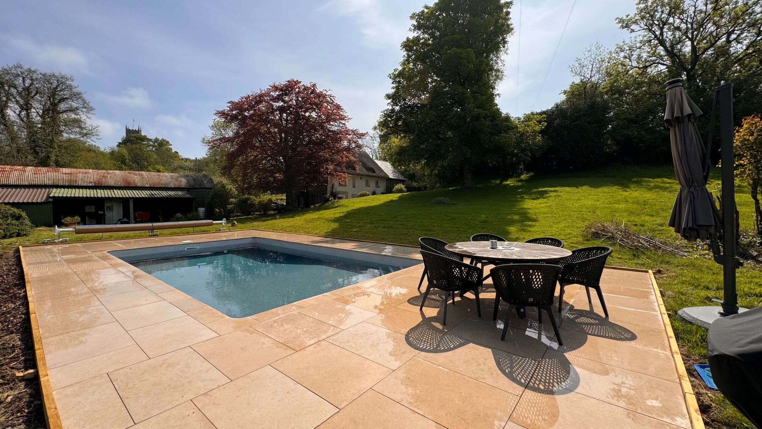 Pool surround slab area with outdoor table and chairs