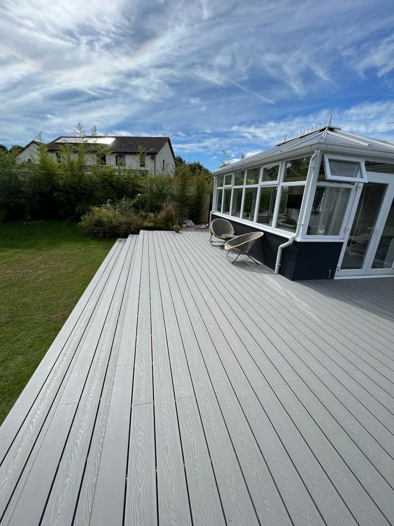 Grey composite decking boards installed in garden