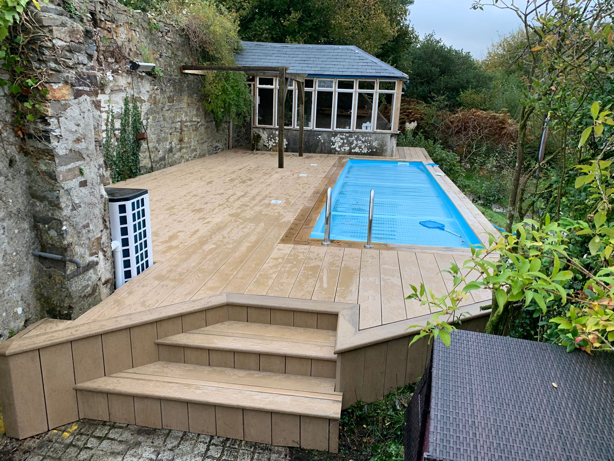 Millboard composite decking around swimming pool