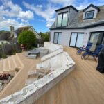 Wooden decking with steps in residential back garden