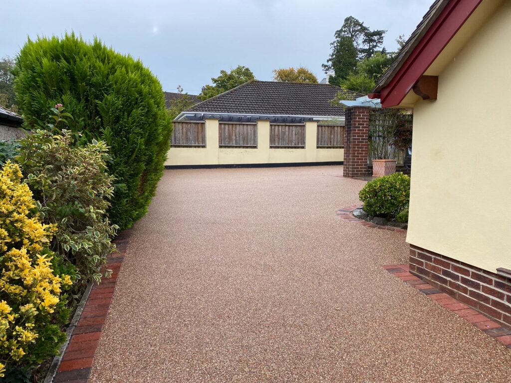 Red resin bound driveway with decorative block paving border, Newton Abbot