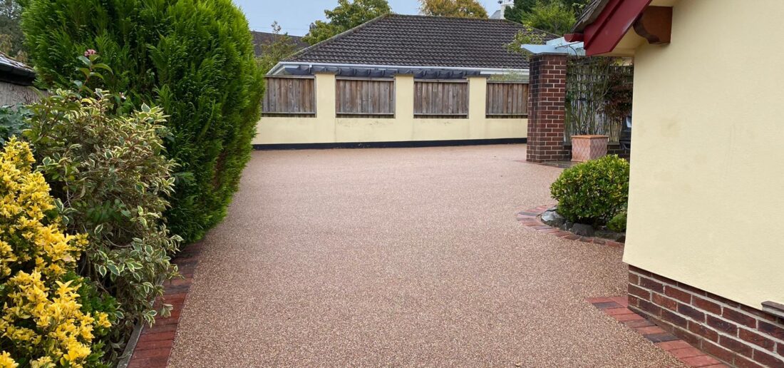 Red resin bound driveway with decorative block paving border, Newton Abbot