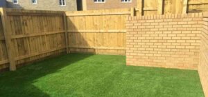 Artificial grass front lawn with timber fencing boundary