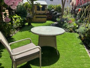 Artificial grass lawn with seating in a narrow Teignmouth town garden