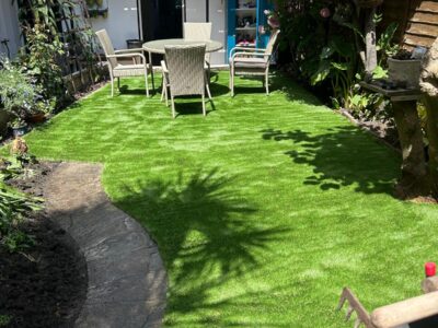 Finished artificial grass lawn and stone path in a Teignmouth town garden