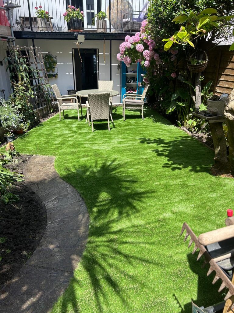 Finished artificial grass lawn and stone path in a Teignmouth town garden