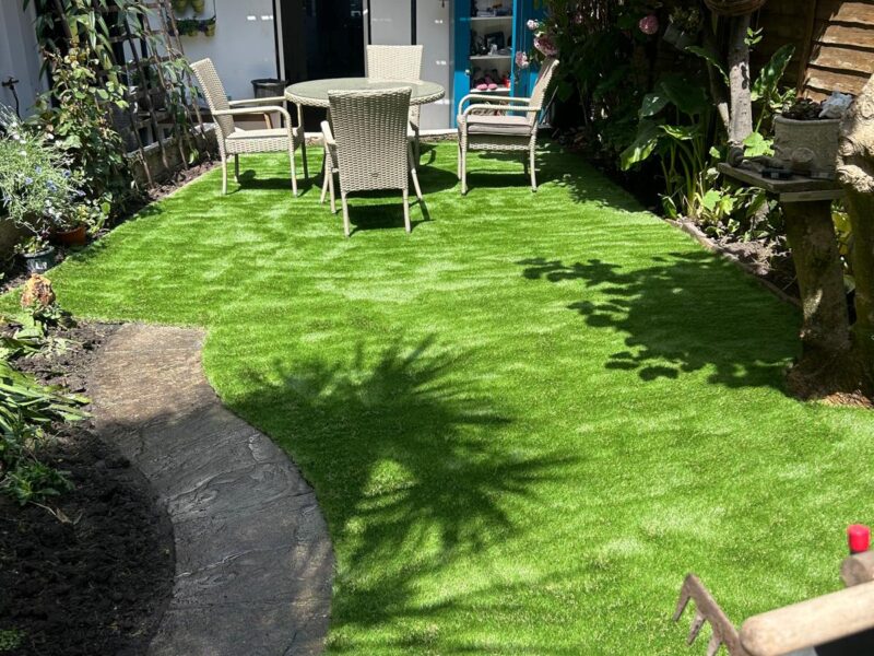 Finished artificial grass lawn and stone path in a Teignmouth town garden