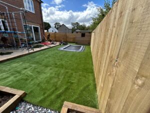 Finished sensory garden with artificial grass and an in ground trampoline