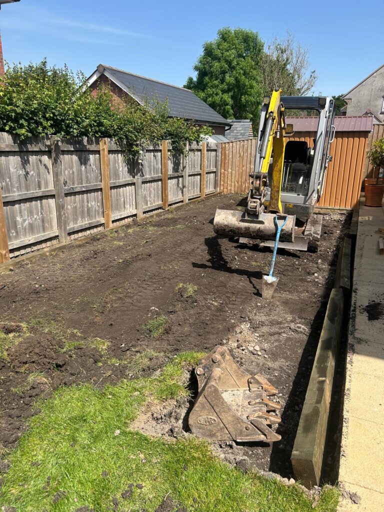 Groundwork and levelling with a mini digger during a sensory garden build